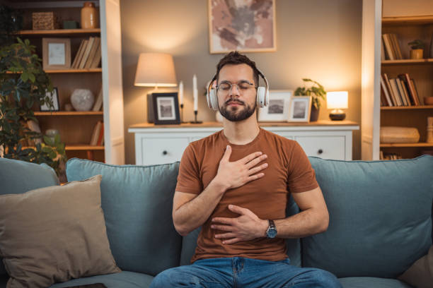 istock A young man with headphones sits on a bed and practices guided meditation 2151169408