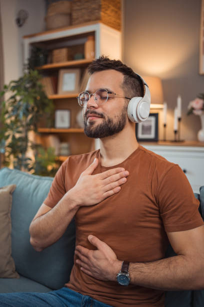 istock A young man with headphones sits on a bed and practices guided meditation 2151169409