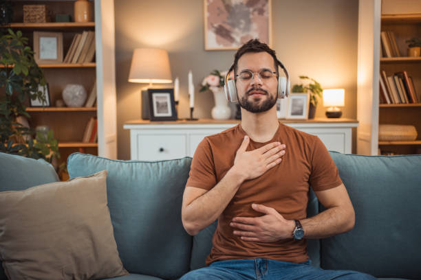 istock A young man with headphones sits on a bed and practices guided meditation 2151169413
