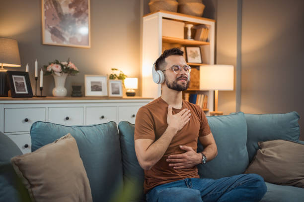 istock A young man with headphones sits on a bed and practices guided meditation 2151169414