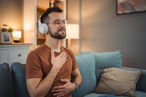 istock A young man with headphones sits on a bed and practices guided meditation 2151169416