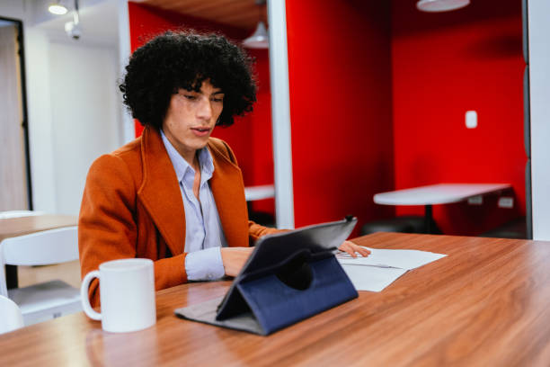 istock Mid adult businessman working using digital tablet in the office 2151171941