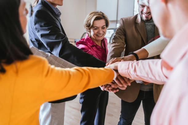 istock Coworkers with stacked hands at the office 2151172637