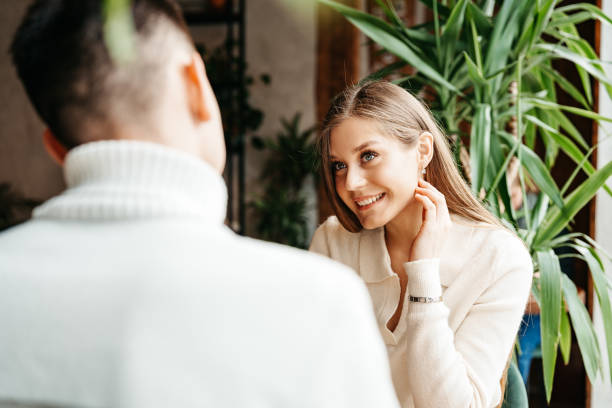 istock Couple Engaged in Conversation at a Cozy Cafe During Daytime 2151174660