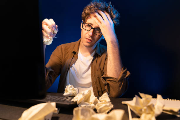 istock Stressful creative working overworked project surrounded crumpled paper. Gusher. 2151175181