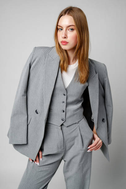 istock Woman in Gray Suit and White Shirt posing in studio 2151176880