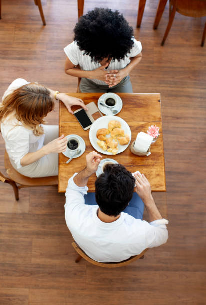 istock Group of friends having coffee and talking in a cafe 2151178800