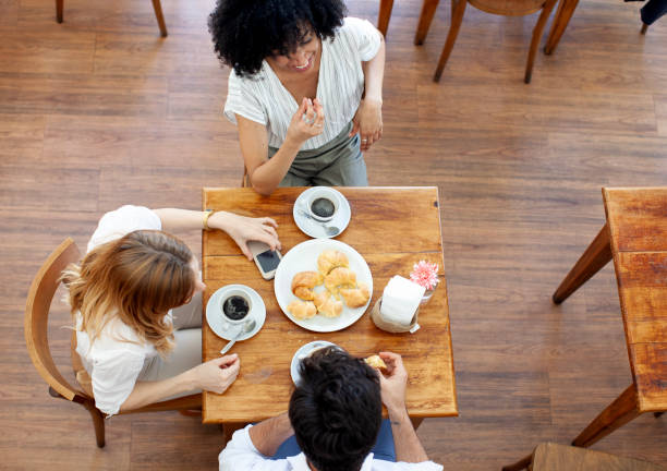 istock Group of friends having coffee and talking in a cafe 2151178810
