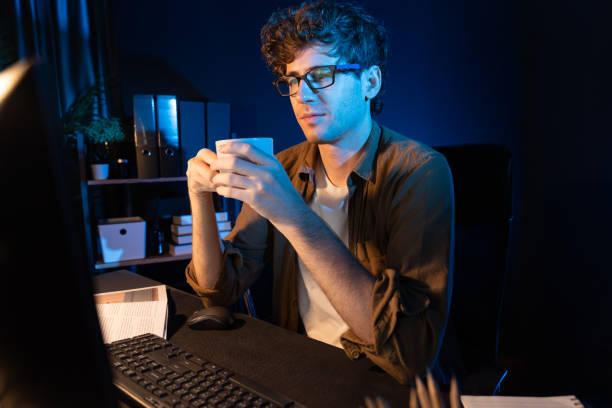 istock Young businessman working job, drinking hot drink with coffee or tea. Gusher. 2151179357