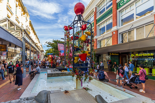 Wellington, New Zealand - March 24, 2024: The Iconic Bucket Fountain in Cuba Street Bedecked with Flowers and Apples for Cuba Dupa Festival 2024, Infusing the Urban Landscape with Colorful Festivity