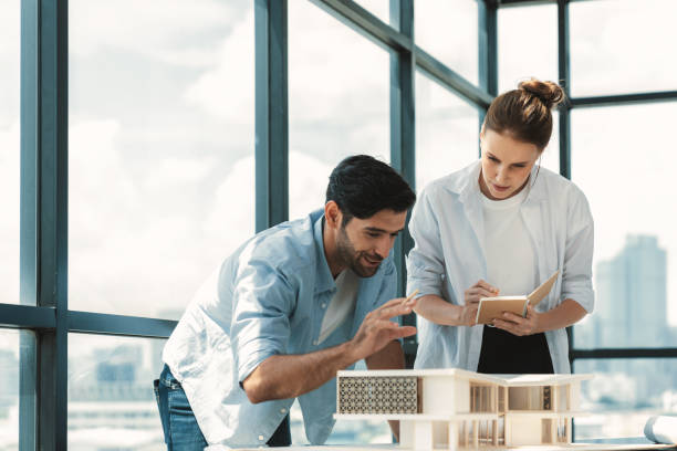 istock Smart architect engineer team working together to measure house model. Tracery. 2151183389