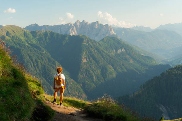 istock Man hiking in Dolomites mountains in summer 2151183888