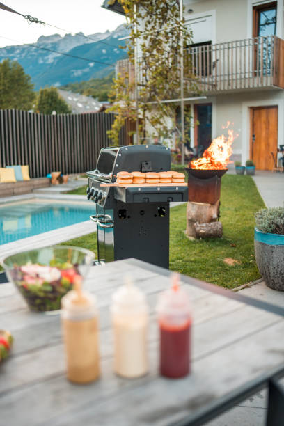 istock Outdoor Backyard Party Setting with Grill and Pool 2151185569