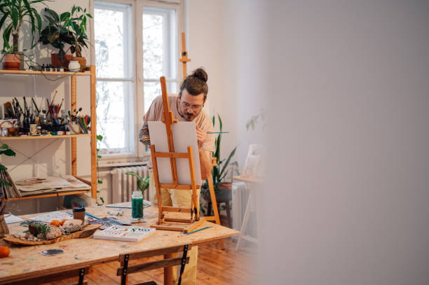 istock Skilled precise trendy painter painting on easel at creative art studio 2151185791