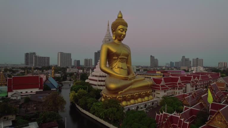 Discover the serene majesty of Bangkok's Golden Buddha through mesmerizing drone views in our captivating footage.