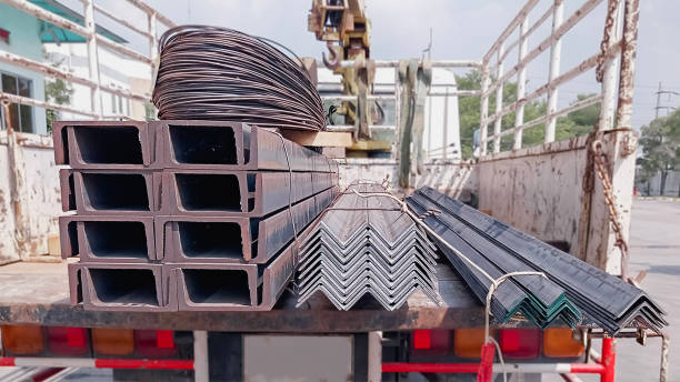 istock Black steel pipe, C-shaped, gutter, flat pipe, and square pipe. Steel construction materials on transport vehicles Construction steel product group Concept images or samples of steel products 2151189324