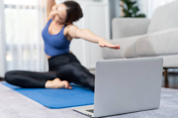 istock Focused laptop on the floor showing online exercise training video. Vigorous 2151189699