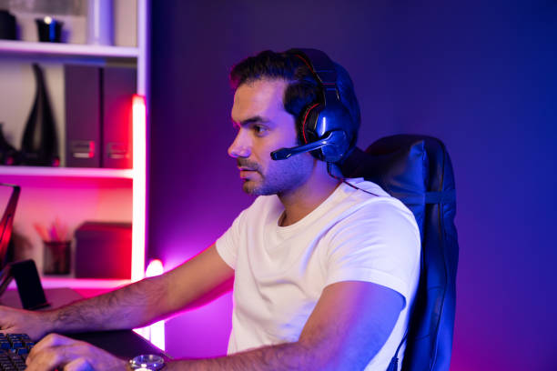 istock Serious face streamer concentrating gaming player trying to pass level. Surmise. 2151189992