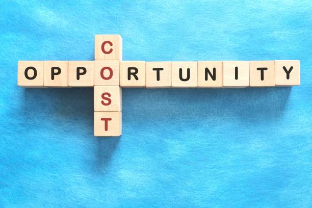 istock Opportunity cost in economics concept. Flat lay in blue background. 2151191995