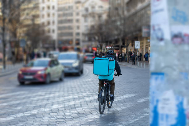 istock delivery courier on electric bicycle 2151192827