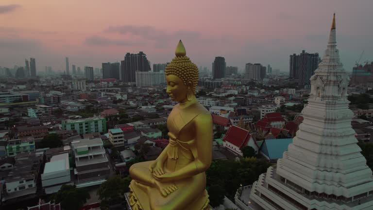 Aerial orbit Phra Buddha Dhammakāya Thepmongkhon at dusk Bangkok, Thailand