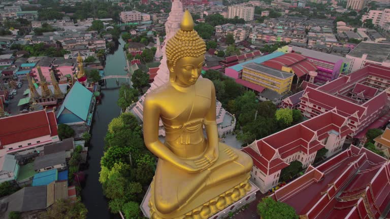 Explore the golden splendor of Bangkok's revered Buddha statue from a bird's eye view with in this captivating drone footage.
