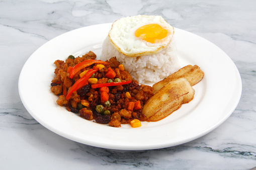 Photo of freshly cooked Arroz A la Cubana or ground meat with vegetables served with rice, egg and fried banana.