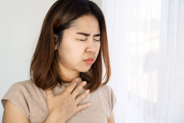 istock Asian woman suffering from nausea and vomiting 2151203284