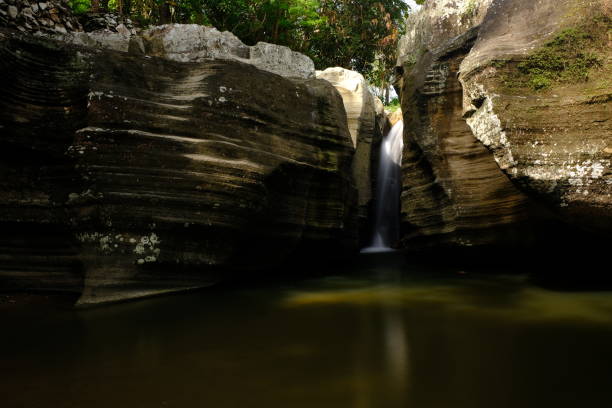 istock waterfall between sedimentary rock walls. natural background. 2151204016