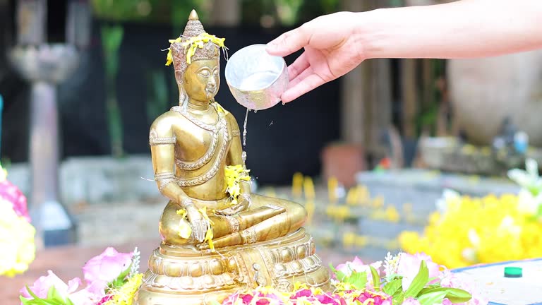 Ritual Pouring Water Over Buddha Statue