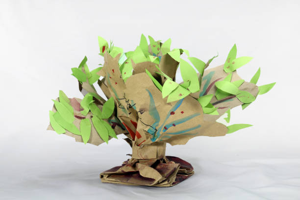 istock A paper tree hand craft made for student's school project. Paper recycling creative idea. just twisting and shaping a paper bag and adding few leaves on it. 2151217231