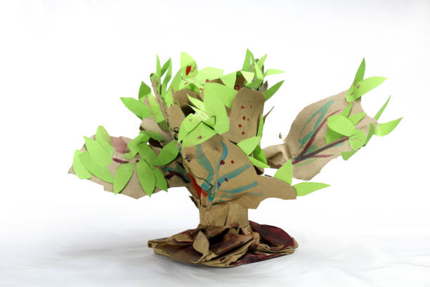 istock A paper tree hand craft made for student's school project. Paper recycling creative idea. just twisting and shaping a paper bag and adding few leaves on it. 2151217232
