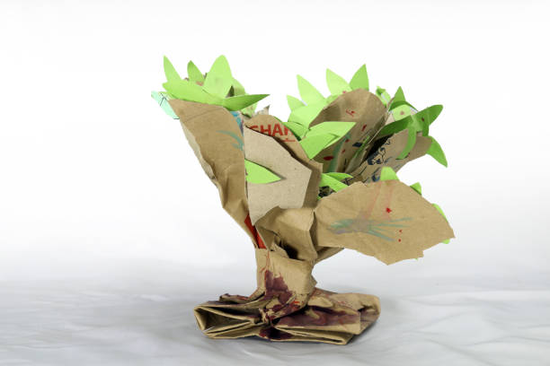 A paper tree hand craft made for student's school project. Paper recycling creative idea. just twisting and shaping a paper bag and adding few leaves on it.