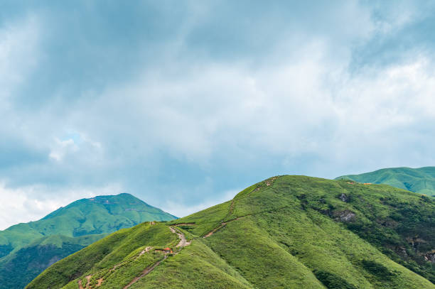 istock Green Mountain Scenery with Cloudy Summer Weather 2151218322