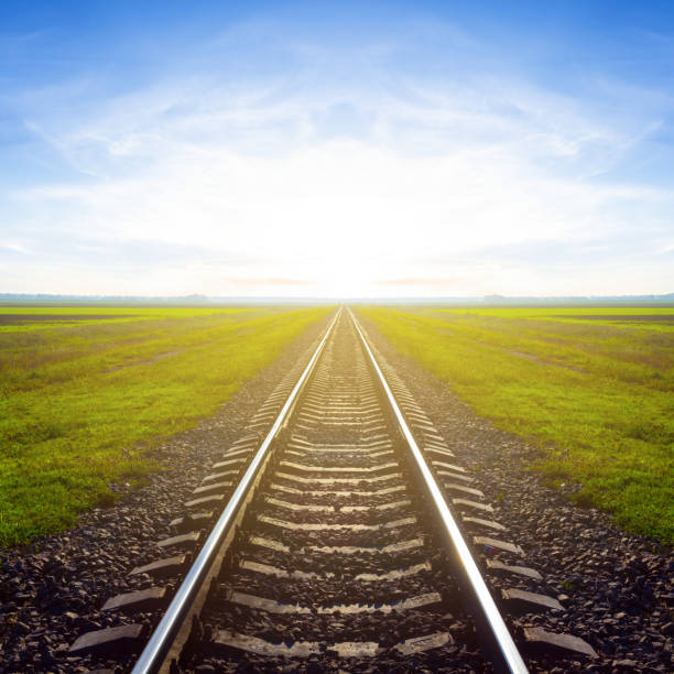 istock railway among green plain at the sunrise 2151219049