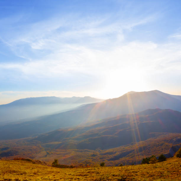 mountain valley in blue mist at the sunset