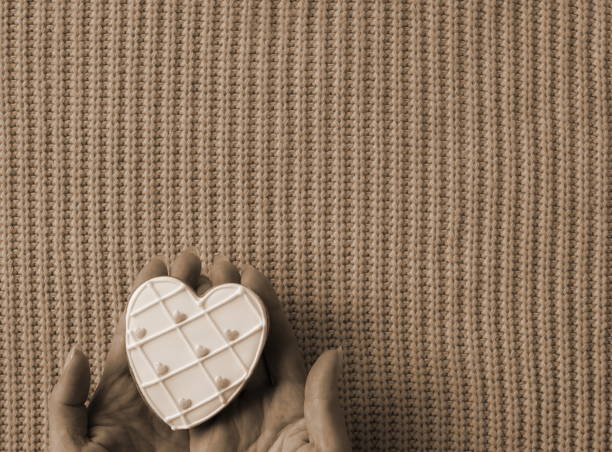 Treasured Love in Sepia Tones. A Heart-Shaped Token Cradled Gently Against a Textured Background. Old Photo