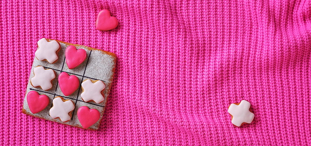 Cute Little Red Heart Pink Background. Warm Knitted Sweater Fabric. Square Banner. Top View