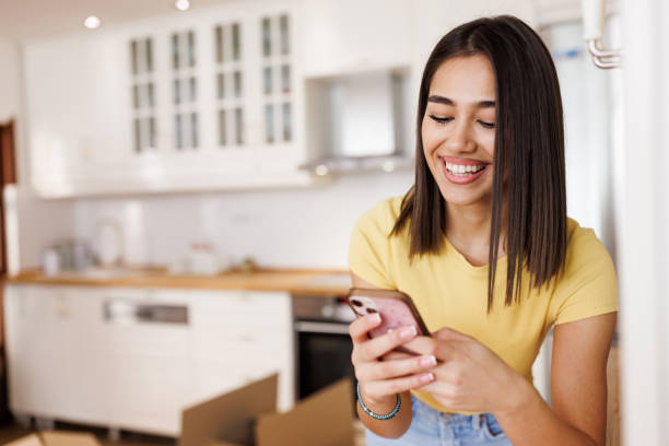 istock Woman using phone in new home 2151220356