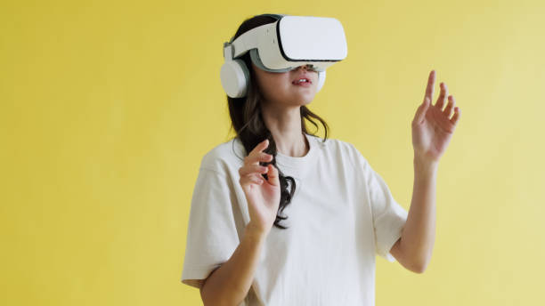 istock Engaged Asian Woman Interacting with Virtual Reality. 2151220866