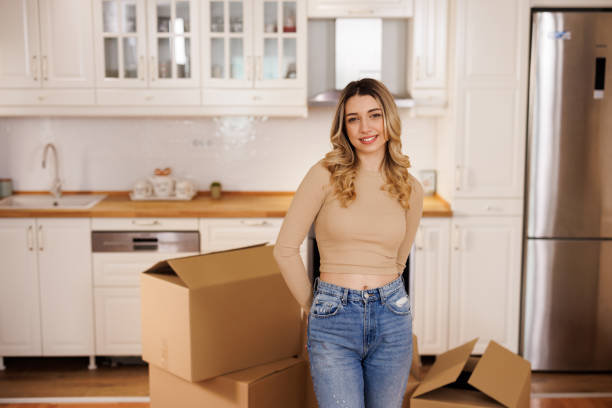 istock Happy young woman is moving into a new house 2151221027