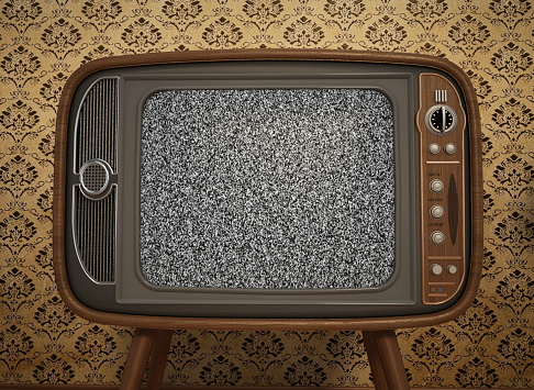 Classic, retro-style CRT television set with a wooden exterior and static screen against a patterned wallpaper backdrop, conveying a nostalgic ambiance of a bygone era.