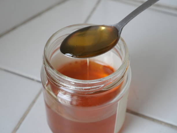 istock honey pot with spoon full of honey 2151221551