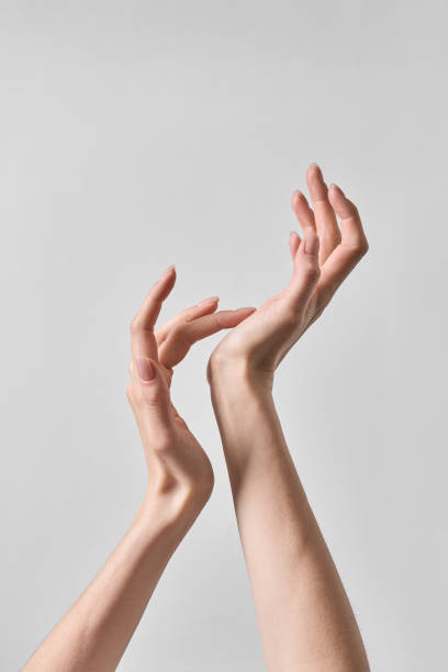 istock Healthy female hands with Long elegant fingers on a uniform background 2151221562
