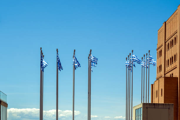 istock flagpoles with the Greek flag against a blue sky 2151223600