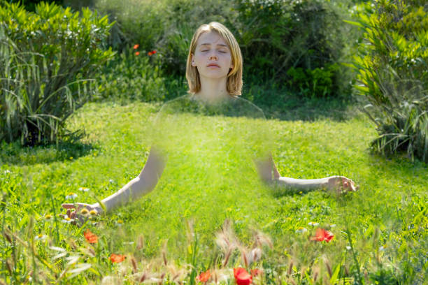 Transparent girl sitting on a grass
