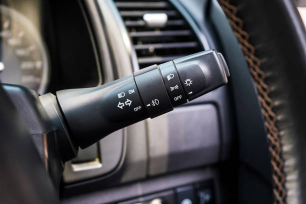Switch off lights in a car. close-up Car integrated turning indicator with headlight switch toggle.
