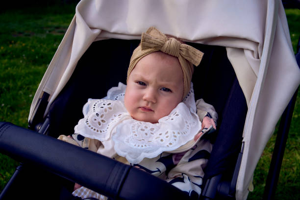 istock cute baby in a stroller in the park 2151224105