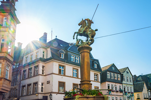 historic market place of Marburg with old town hall and fountain at morning hour in summer