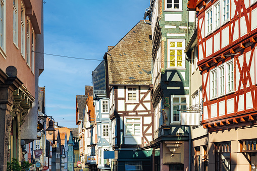 alley in old town Marburg with colorful half-timbered  houses under blue summer sky